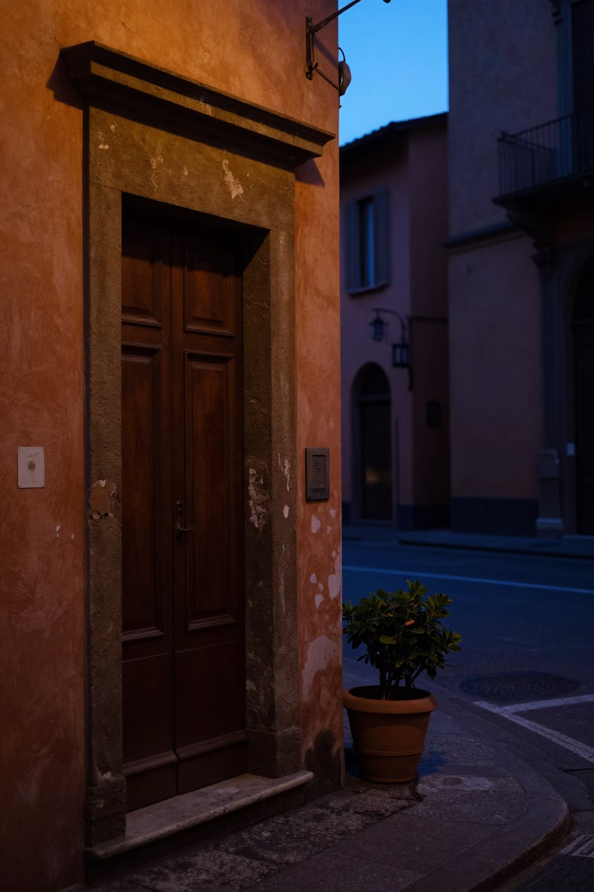 Predawn Bologna Street Scene with Doorframe and Flowerpot in Early Morning Darkness in in Bologna, Italy