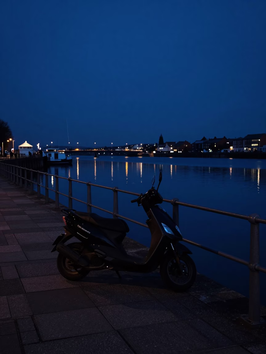 Predawn Bristol Harbor Promenade with Parked Scooter and Distant City Lights in in Bristol, United Kingdom
