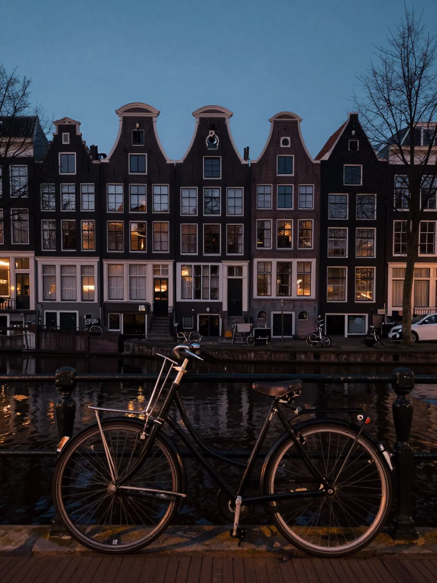 Predawn Canal Scene in Amsterdam with Vintage Bicycle and Brick Architecture in in Amsterdam, Netherlands