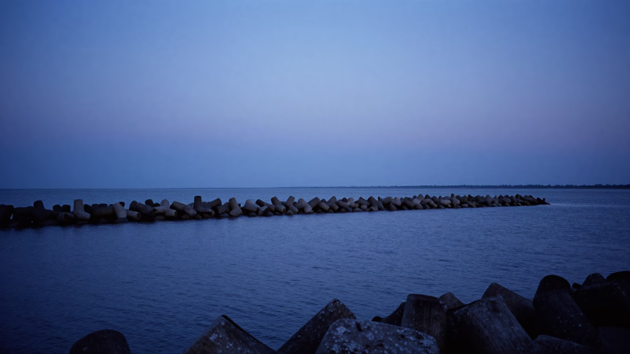 Predawn Charleston Harbor Breakwater with Fading Blue Sky and Rusty Doorframe Details in in Charleston, South Carolina, United States