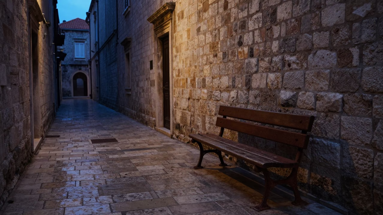 Predawn Dubrovnik stone alleyway with rusted bench and empty street in in Dubrovnik, Croatia