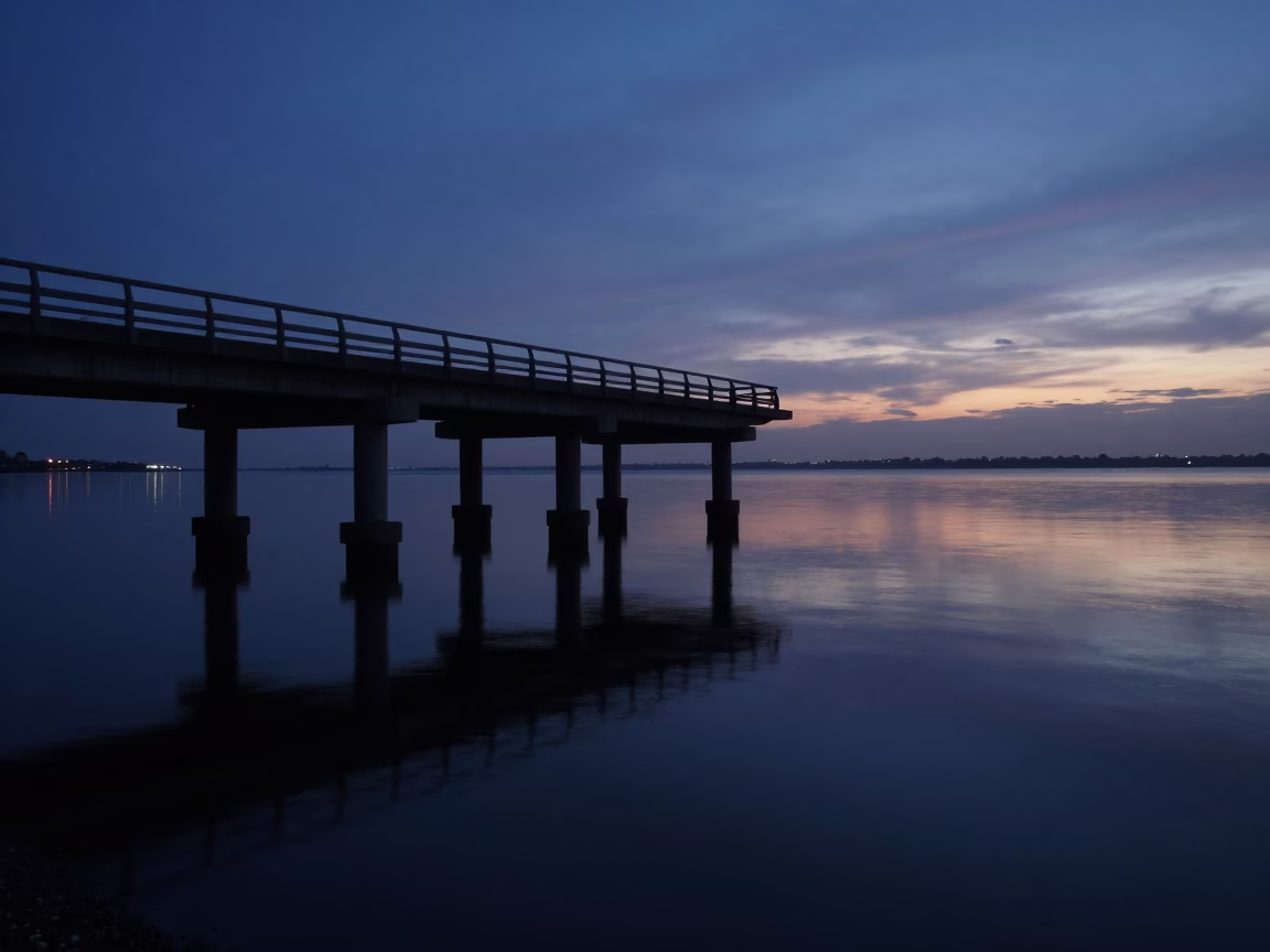 Predawn Durban Harbor Bridge Pier in Mirror-Still Water with Faint Starlight in in Durban, South Africa