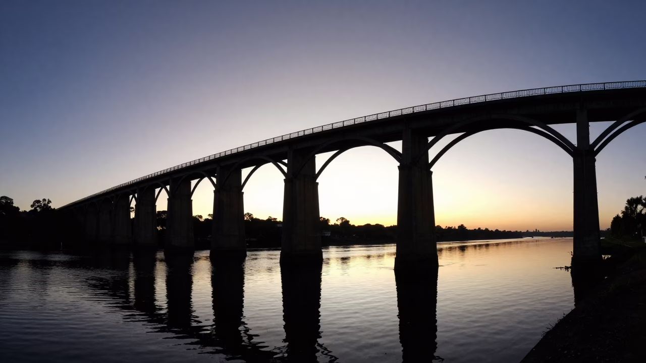 Predawn Durban Railway Viaduct Arches Over Still Water with Bridge Pier in in Durban, South Africa