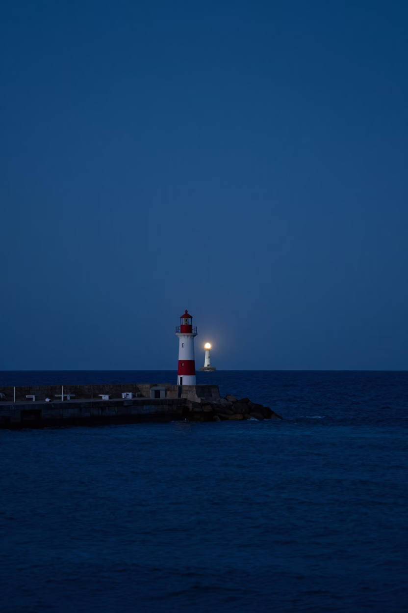 Predawn Harbor View of Nice France with Distant Lighthouse and Calm Mediterranean Sea Horizon in in Nice, France