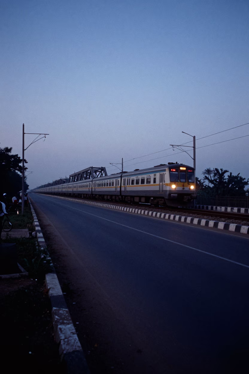 Predawn Hyderabad Street Scene with Commuter Train Crossing Bridge in Blue Hour in in Hyderabad, India