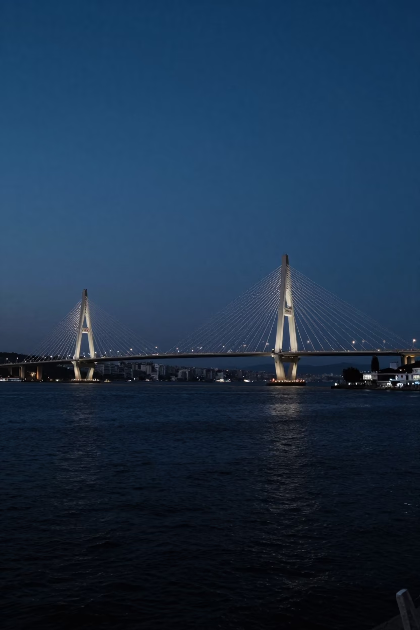 Predawn Izmir Turkey Cable Stayed Bridge Illuminated Against Dark Harbor Water in in Izmir, Turkey