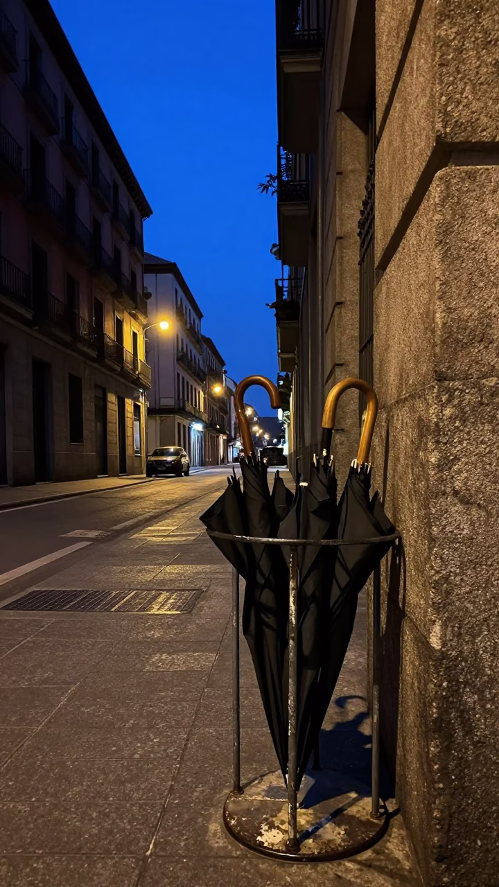 Predawn Madrid Street Scene with Umbrella Stand and Brushed Steel Details in in Madrid, Spain