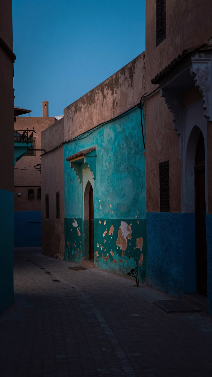Predawn Marrakech Street Scene with Peeling Turquoise Paint and Bougainvillea in in Marrakech, Morocco