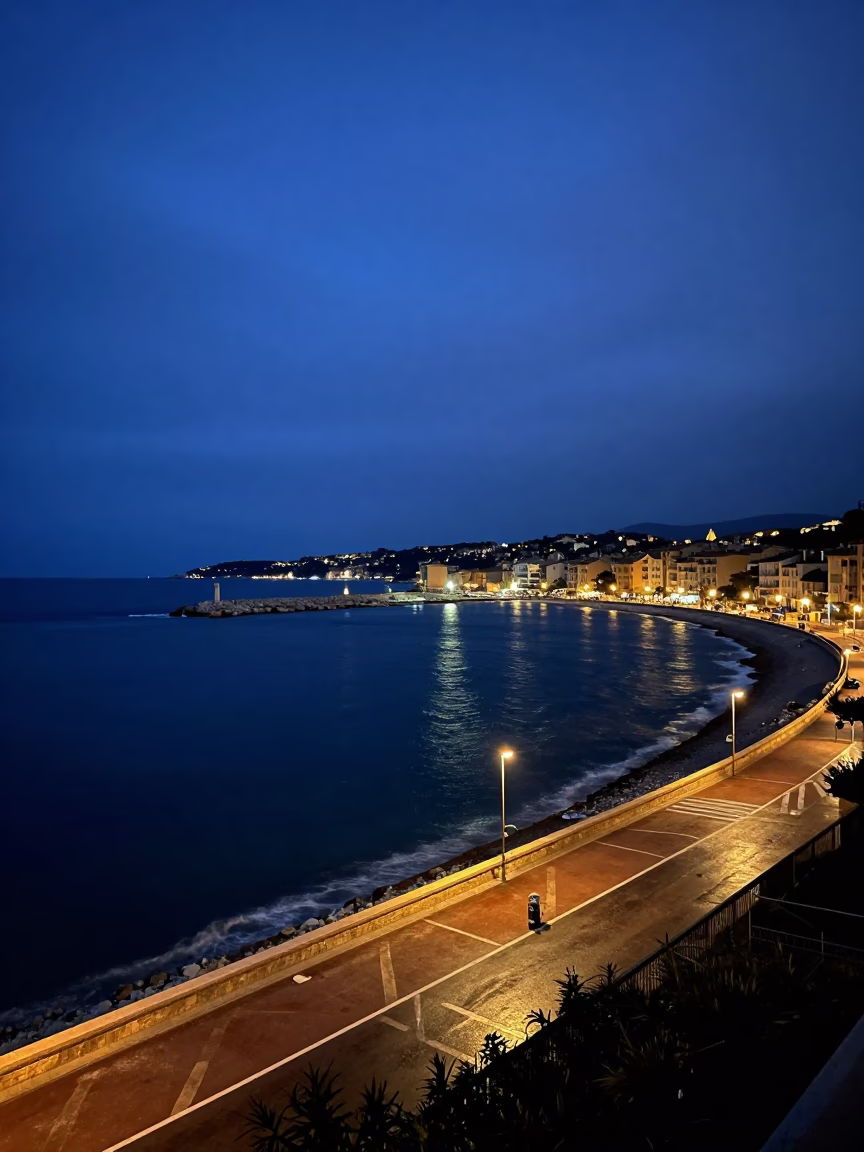Predawn Mediterranean Coastline in Nice France with Harbor Lights and Early Morning Sea Mist in in Nice, France