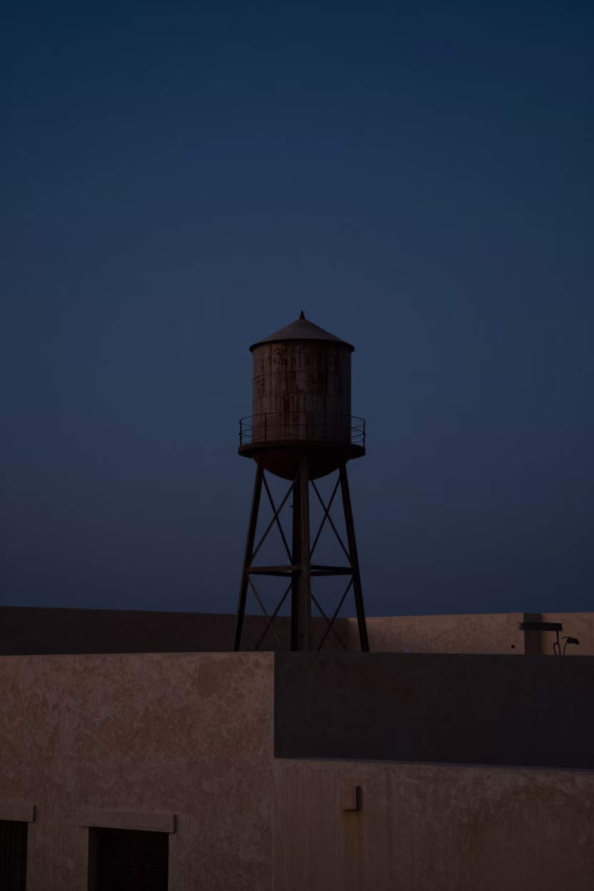 Predawn Muscat Oman Water Tower Rooftop Silhouette Against Dark Sky in in Muscat, Oman