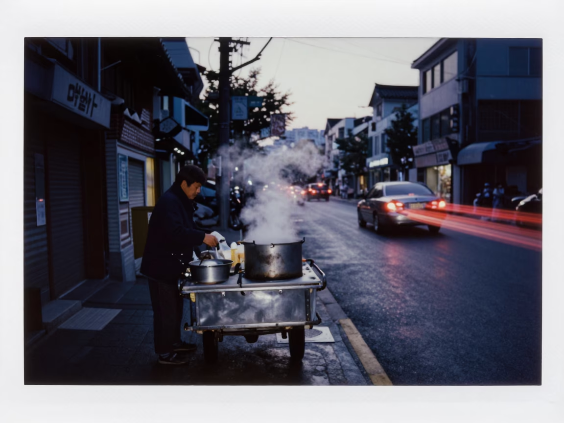 Predawn Seoul Street Scene with Vendor Cart and Taillight Streaks on Wet Asphalt in in Seoul, South Korea