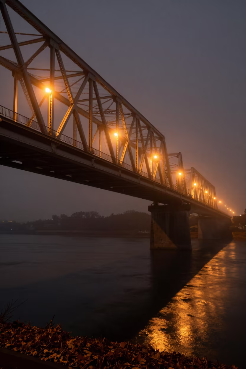 Predawn Steel Truss Bridge Shadows on River in under a viaduct of steel and concrete near Naha