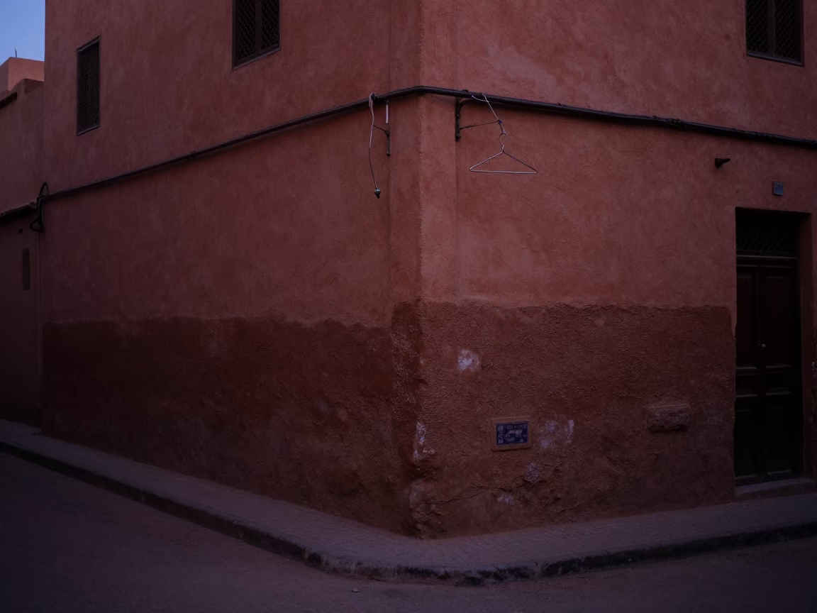 Predawn Street Corner in Marrakech Morocco with Dusty Walls and Hanging Shirt in in Marrakech, Morocco