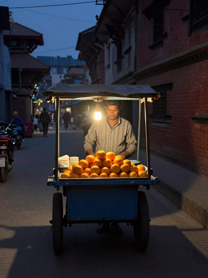 Predawn street food vendor serving hot oranges in Kathmandu Nepal before sunrise in in Kathmandu, Nepal