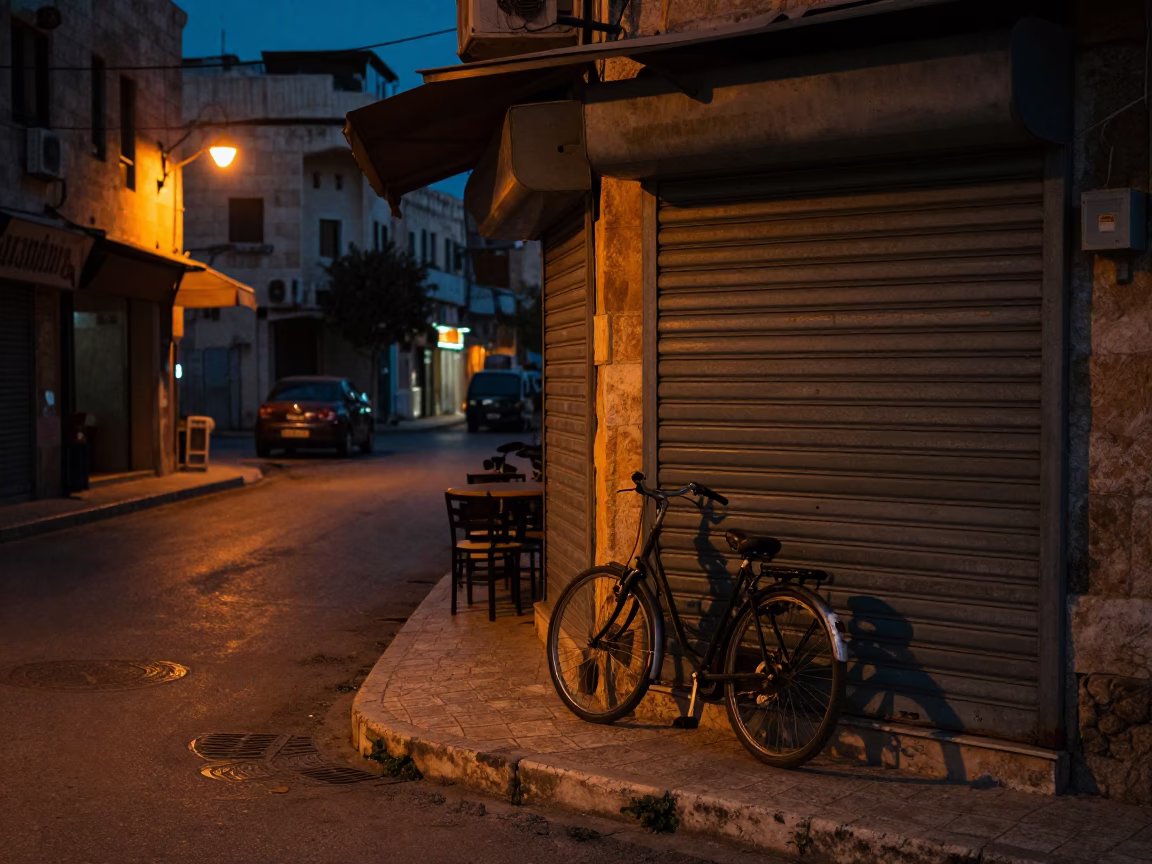 Predawn Street Scene in Amman Jordan with Bicycle Leaning Against Closed Cafe Door in in Amman, Jordan