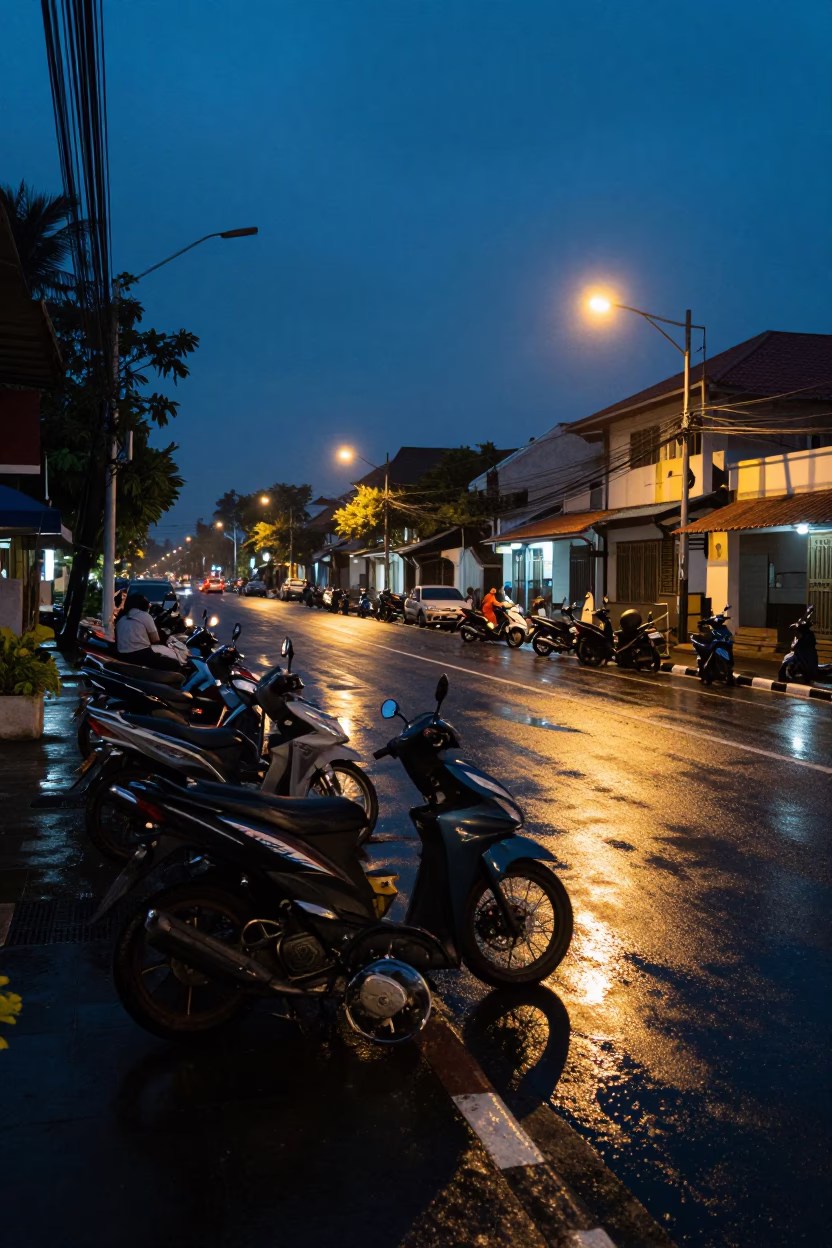 Predawn Street Scene in Denpasar Indonesia with Motorcycles and Wet Pavement in in Denpasar, Indonesia