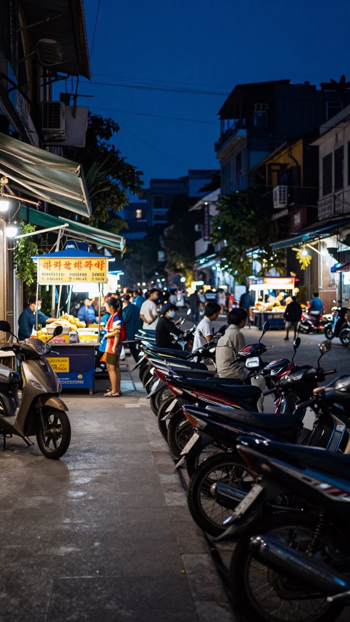 Predawn street scene in Hanoi Vietnam with motorbikes and street food vendors in in Hanoi, Vietnam