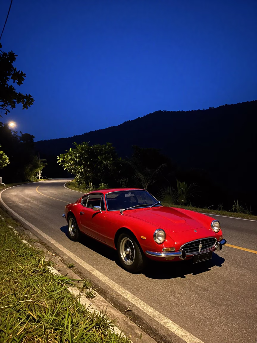 Predawn Street Scene in Phuket Thailand with Vintage Red Sports Car on Mountain Road in in Phuket, Thailand