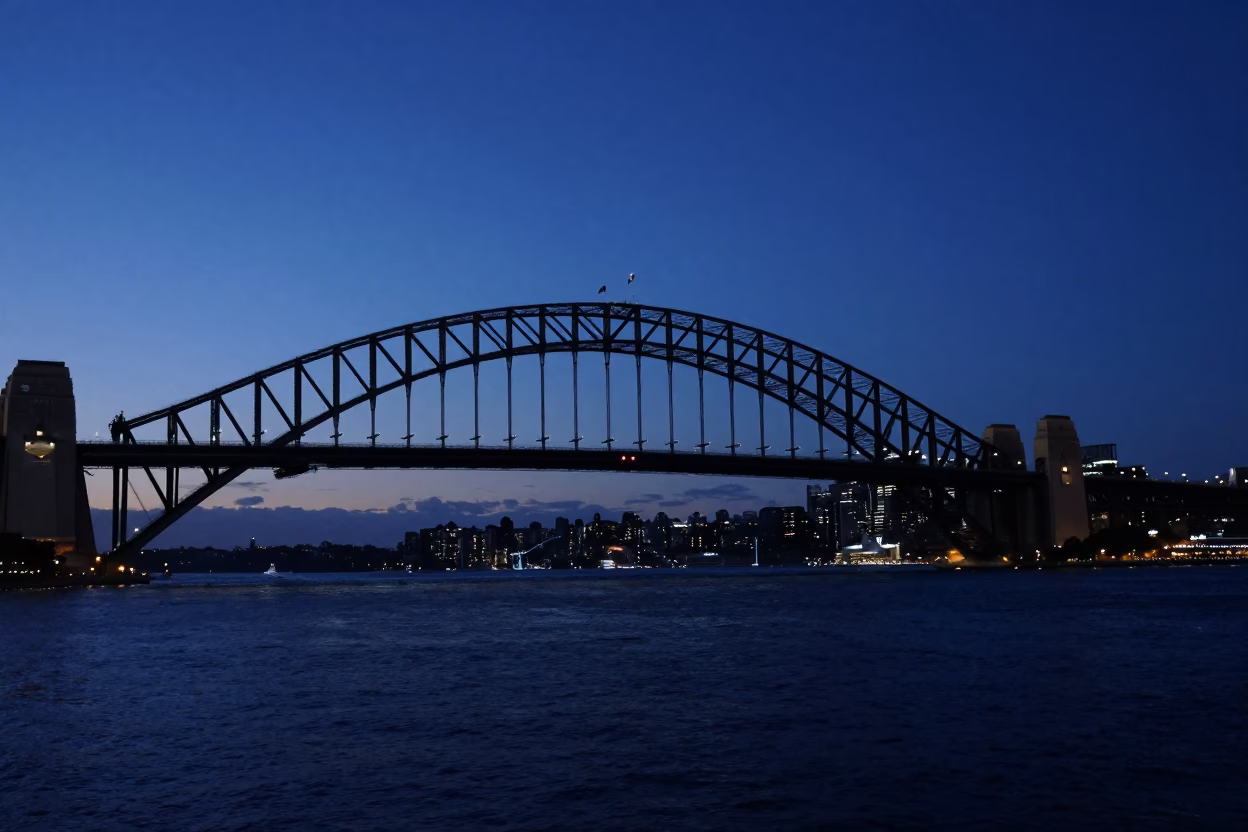 Predawn Sydney Harbour Bridge Silhouette Over Dark Water With City Lights in in Sydney, New South Wales, Australia
