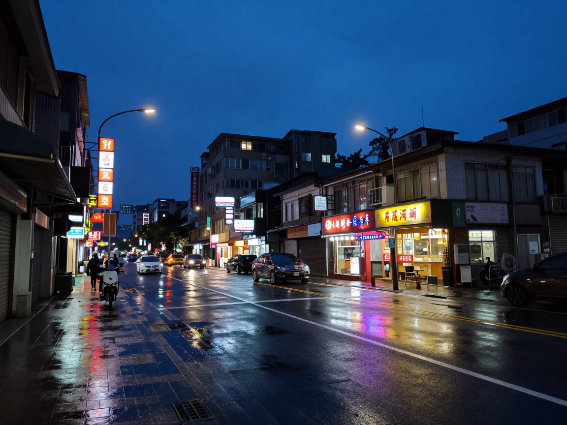 Predawn Taipei streetscape with neon signs and wet pavement reflections in in Taipei, Taiwan