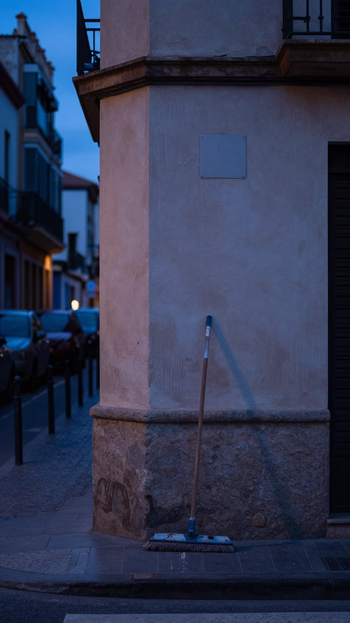 Predawn Valencia Street Scene with Water Marks on Plaster and Dust Mop in in Valencia, Spain