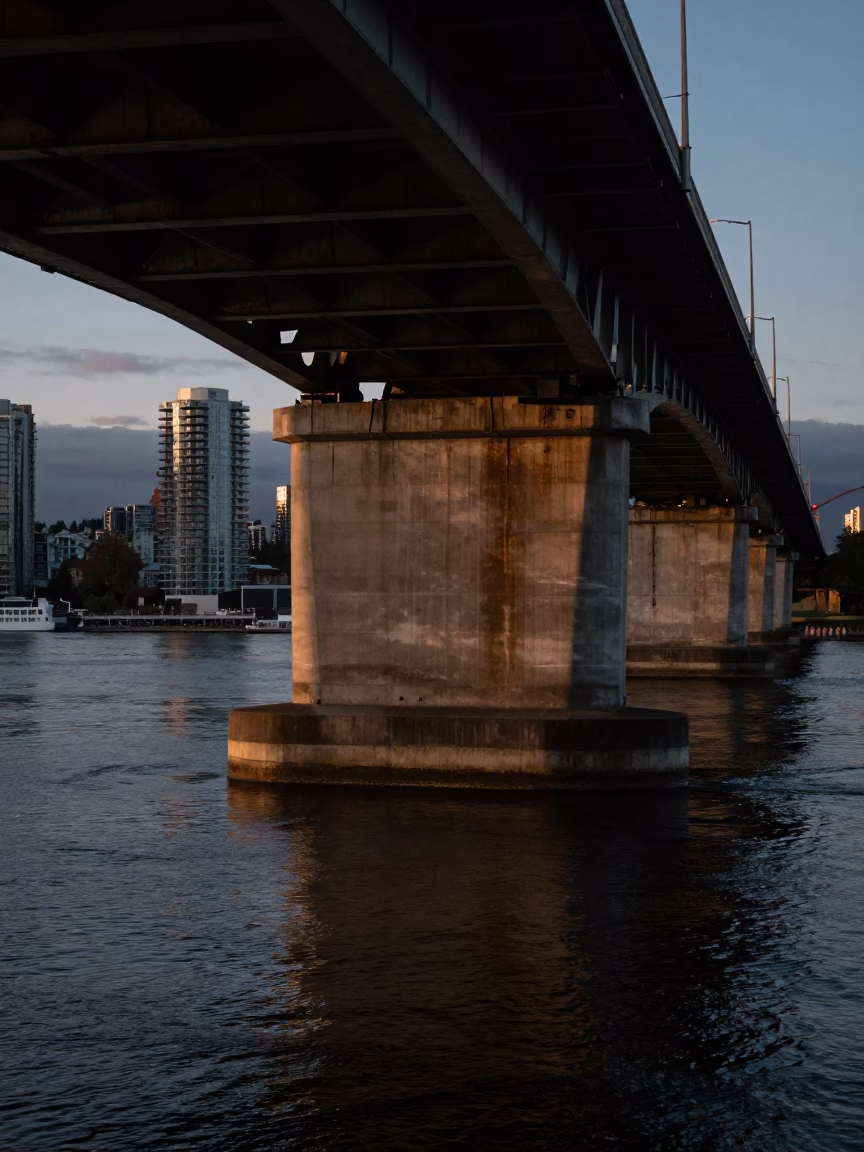 Predawn Vancouver Burrard Street Bridge Pier Splitting Brown Water with Pigeons and Brush in in Vancouver, British Columbia, Canada