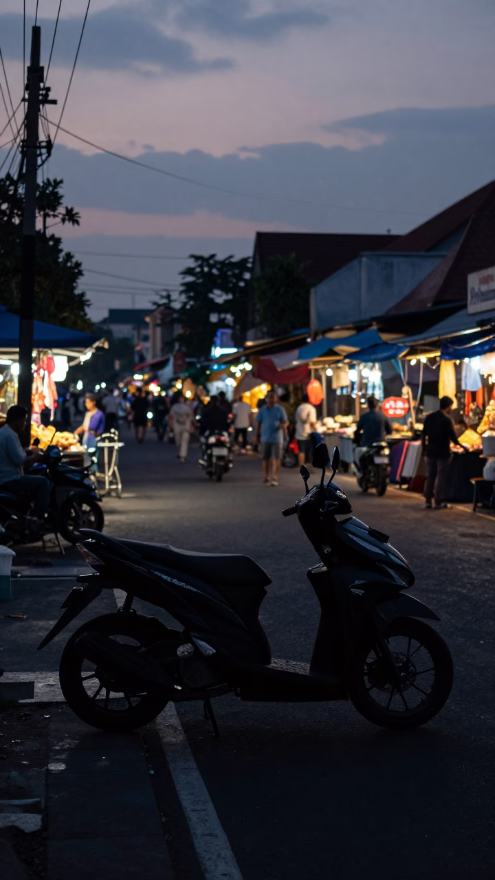 Predawn Yogyakarta Street Scene with Scooter and Local Market Activity in in Yogyakarta, Indonesia