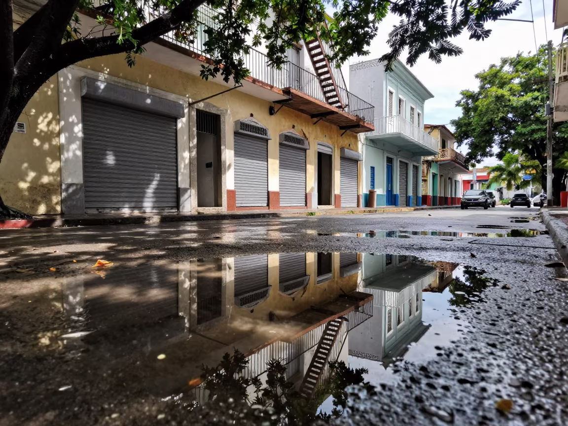 Puddle Reflection of Fire Escape in San Pedro in along a shuttered arcade in San Pedro de Macorís