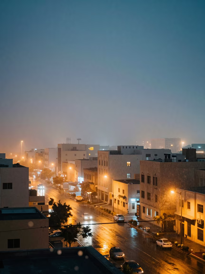 Qatar Night Drizzle and City Lights in through low marine fog in Qatar