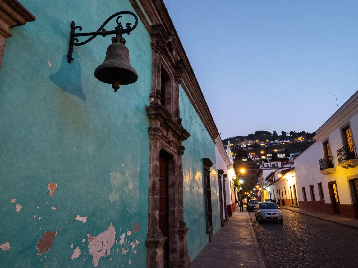 Quito Ecuador Evening Street Scene With Bell And Peeling Turquoise Paint in in Quito, Ecuador