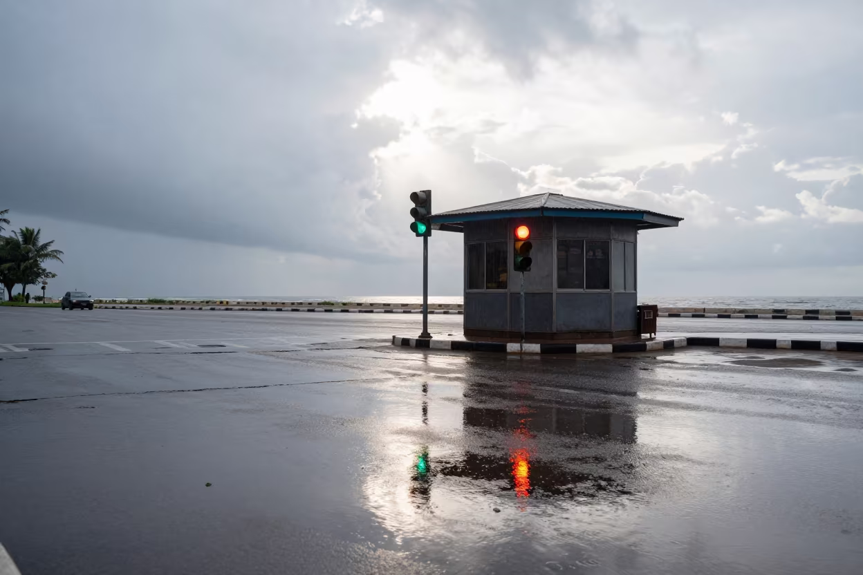Rain Darkened Kiosk Street Corner Traffic Light Reflection in by a rain-darkened kiosk in Jinja