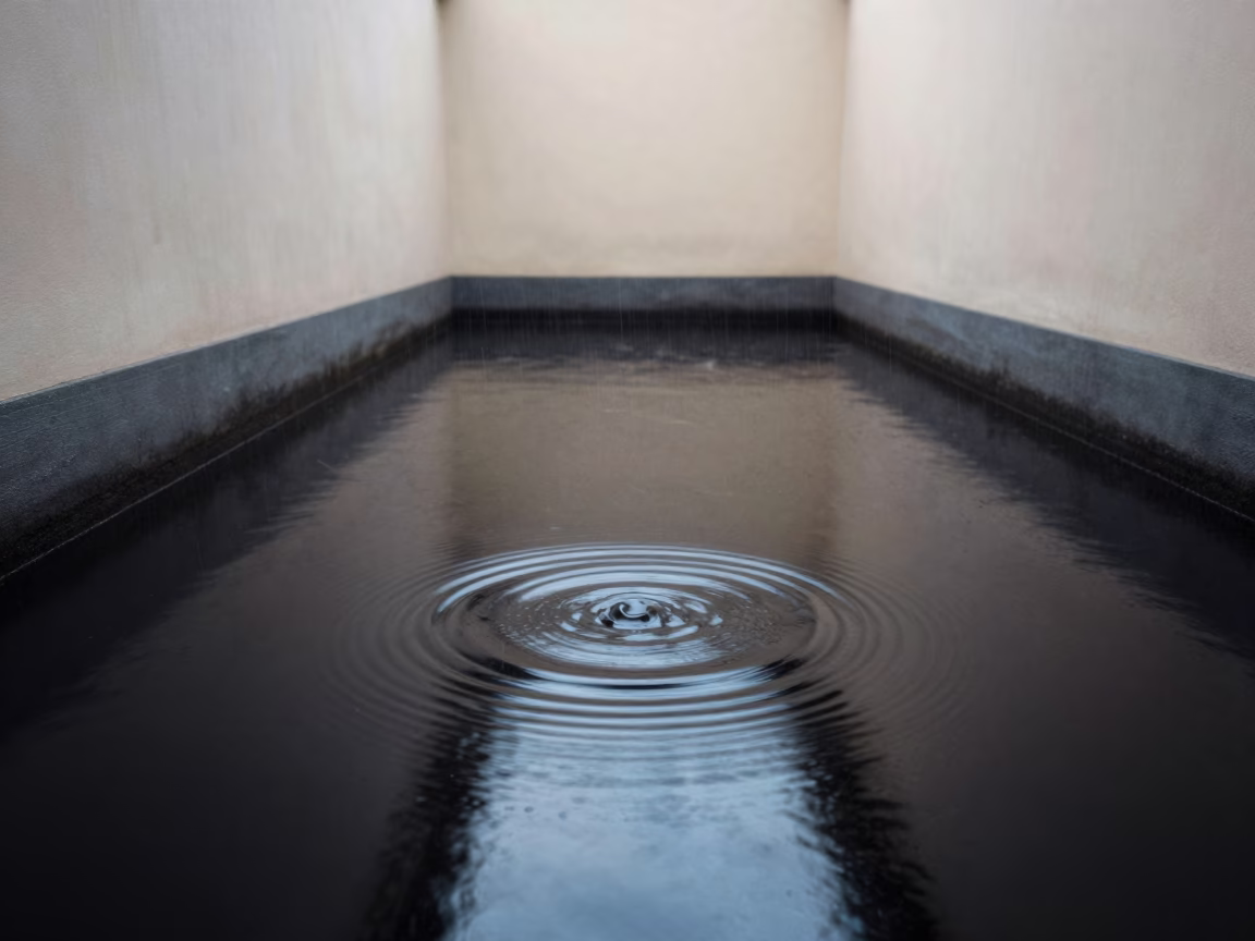 Rain Rings on Black Water Morning Light in inside a skylit passageway in Damaturu