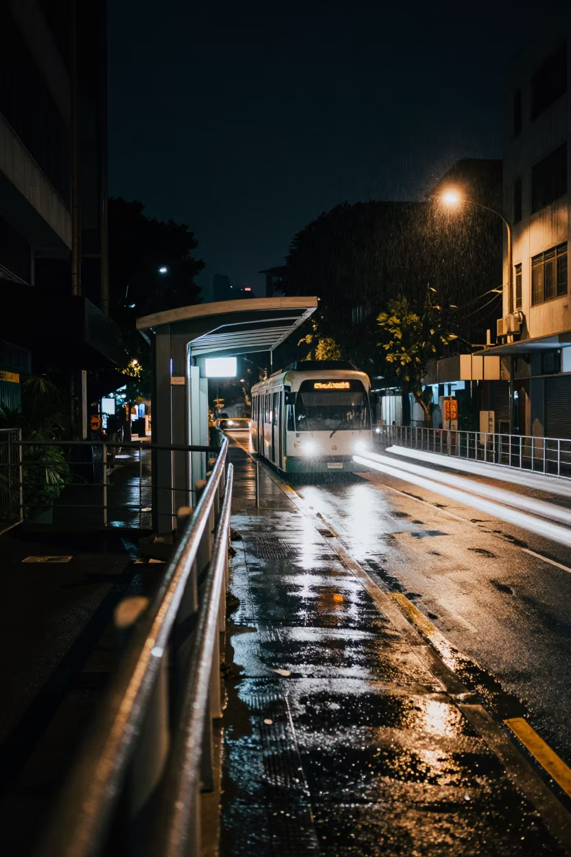 Rain soaked overpass railing glowing city below Bukit Bintang in at a tram stop in Bukit Bintang, Kuala Lumpur