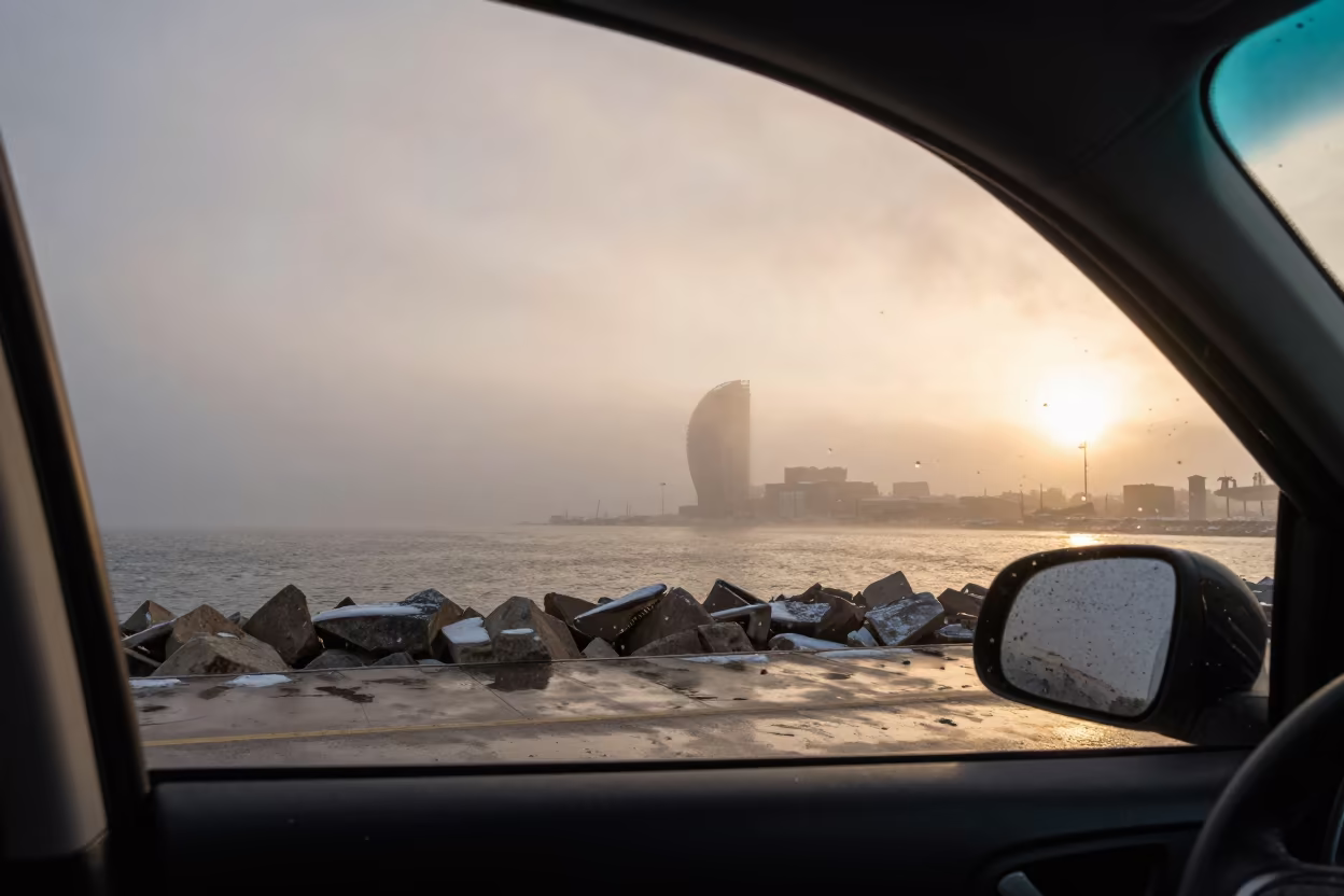 Rain Streaks on Car Window at Barcelona Harbor in beside a fogbound harbor mouth near Barcelona