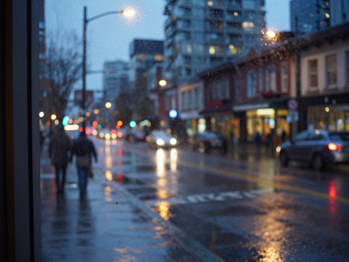 Rainy Vancouver Evening Street Scene with Wet Glass and City Lights in in Vancouver, British Columbia, Canada