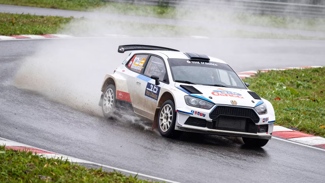Rally Car Kicking Up Gravel on Bend in near Thủ Đức