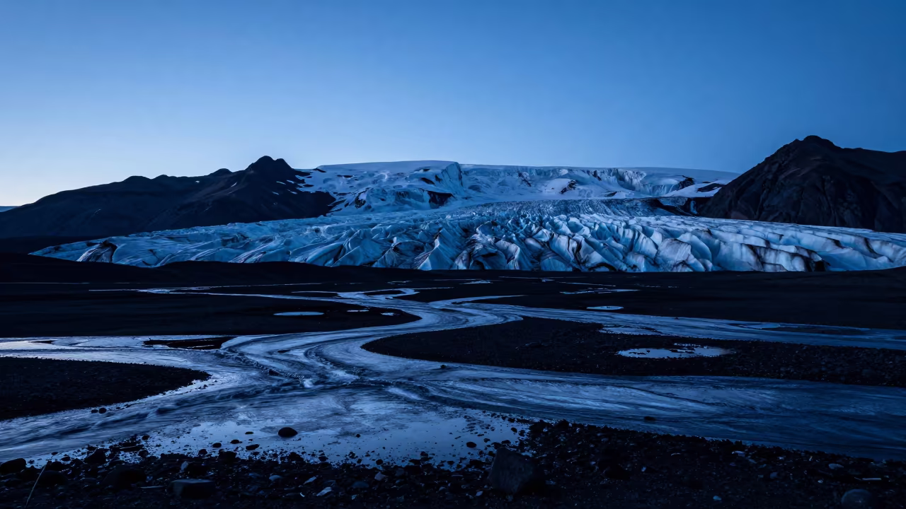 Receding Glacier Silhouette Against Steel Blue Sky in across a floodplain after rain near Rovaniemi