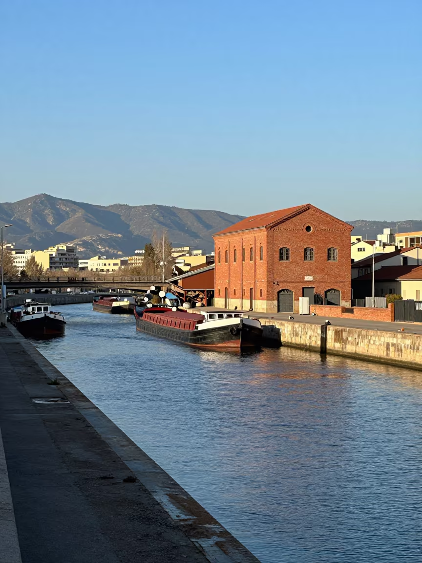 Red Brick Mill and Barges on Gracia Causeway in on a wind-open causeway near Gracia, Barcelona