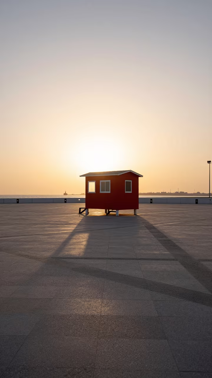Red Norwegian Cabin Silhouette on Bahrain Plaza in across a formal civic plaza in Bahrain