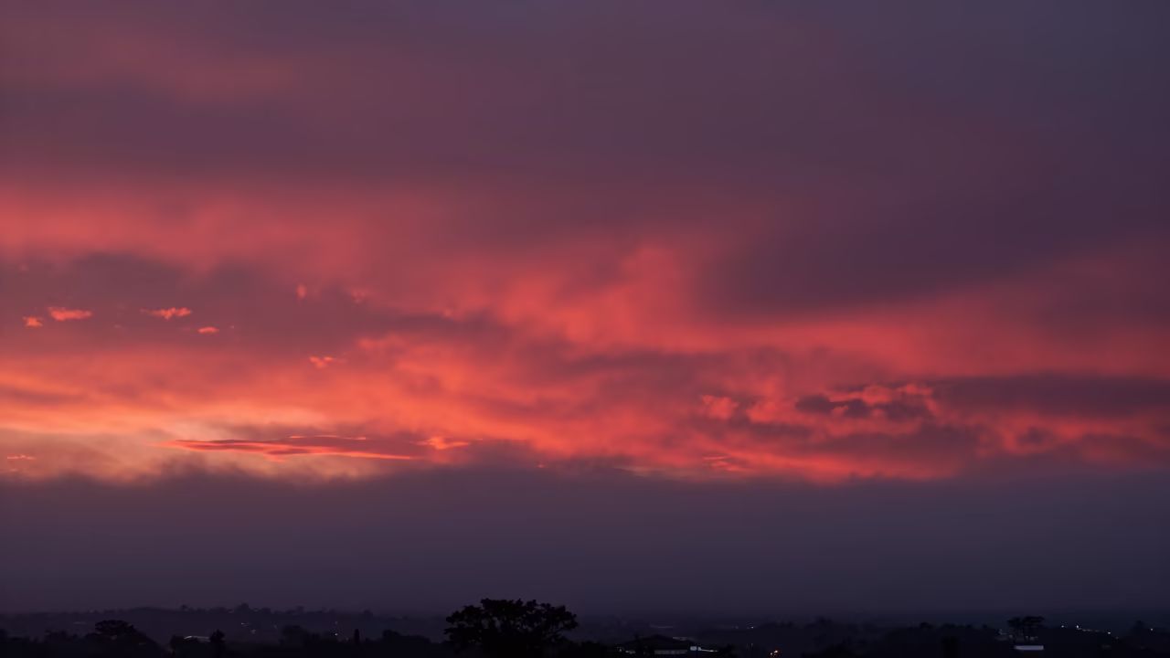 Red Sunset Sky Through Marine Fog Near Asuncion in through low marine fog near Asuncion