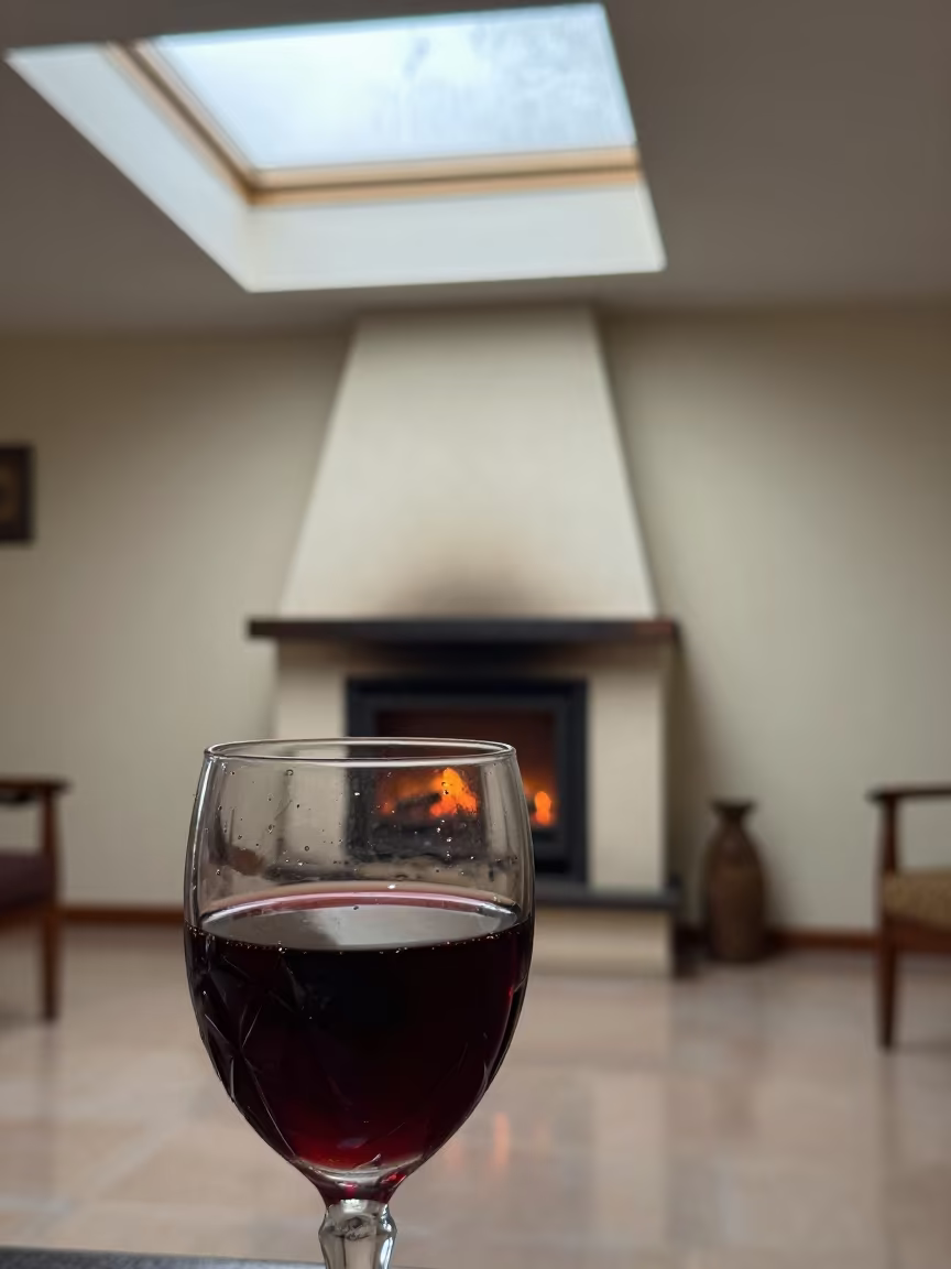 Red Wine Reflection of Fireplace in Kisangani Room in by a crackling fireplace in Kisangani