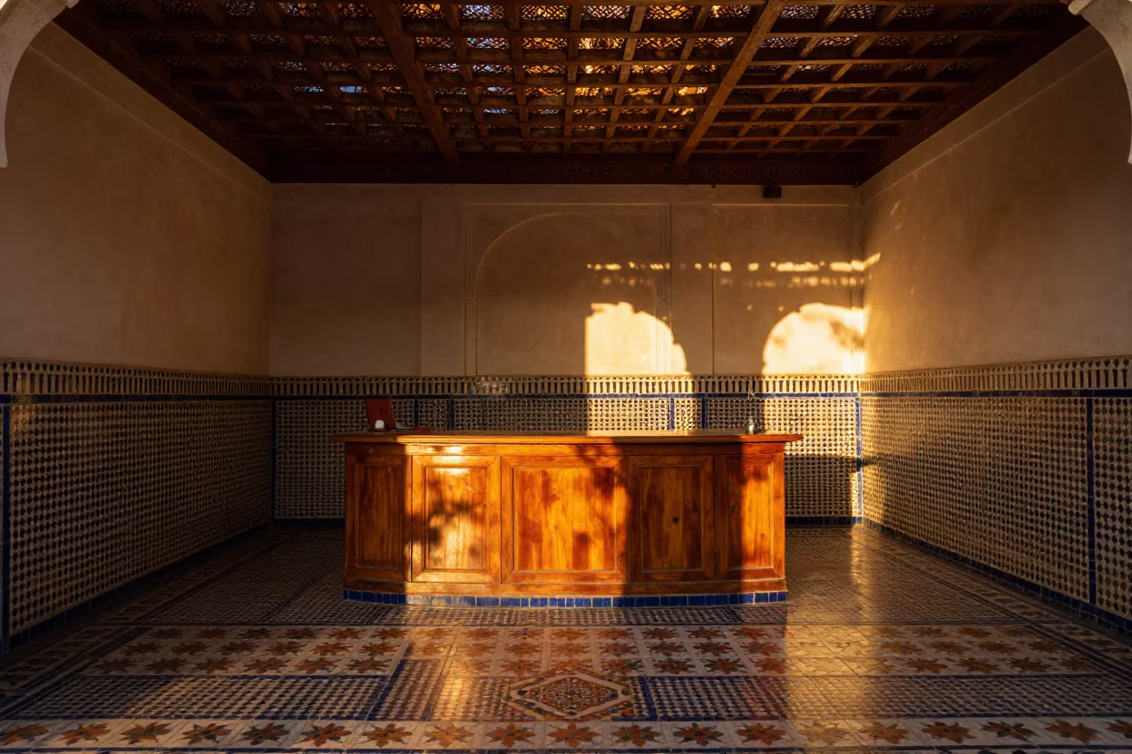 Riad Plunge Pool Court Cedar Lattice Fez in at a reception desk under warm light in Bab Bou Jeloud, Fez