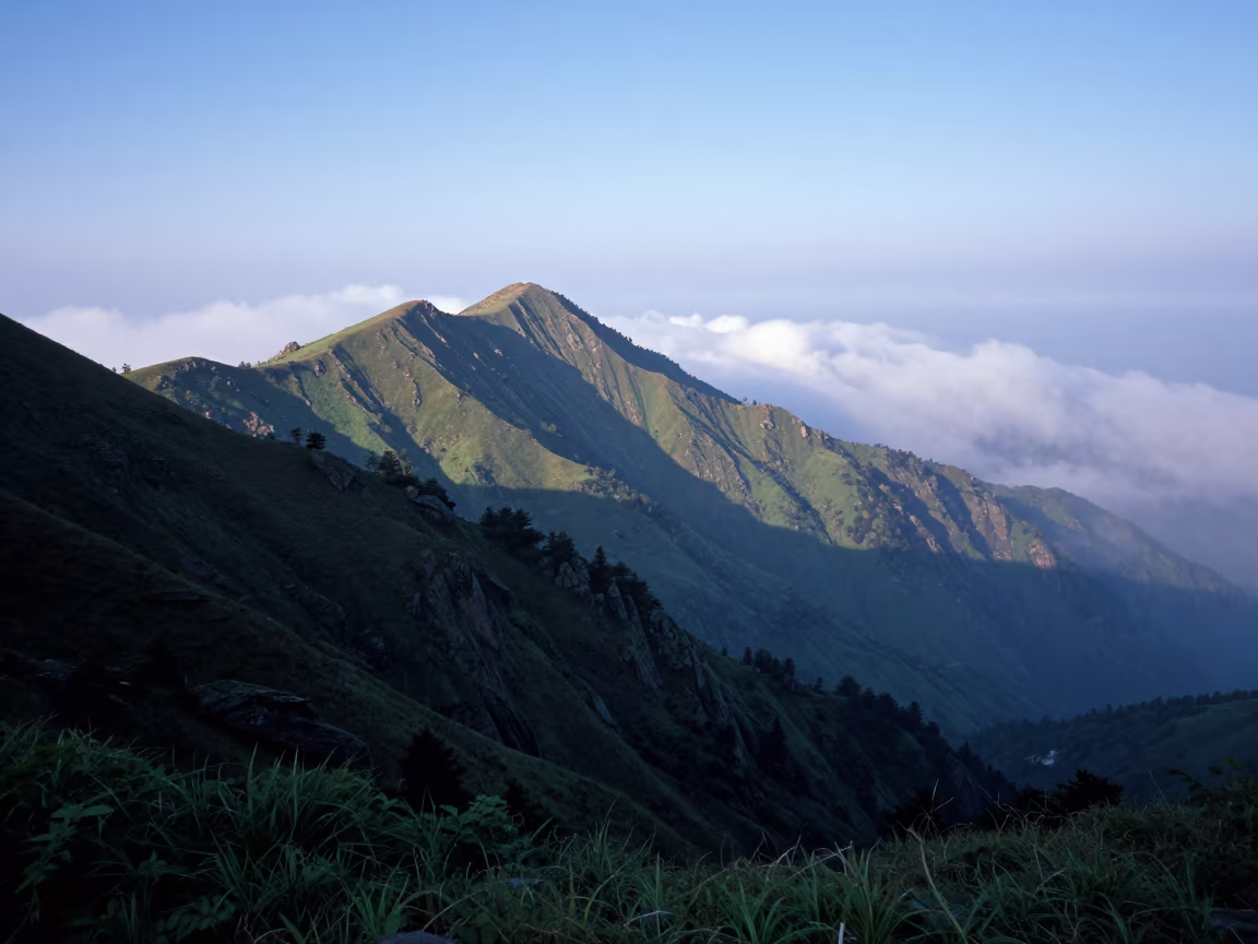 Ridge Above Clouds in Himachal Evening Mist in across a wide valley floor in Himachal Pradesh