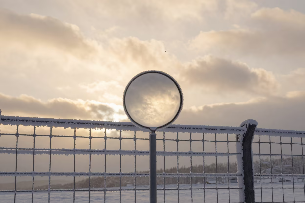 Rime Ice on Wire Fence at Golden Hour in beneath fast-moving cloud bands near Sapporo