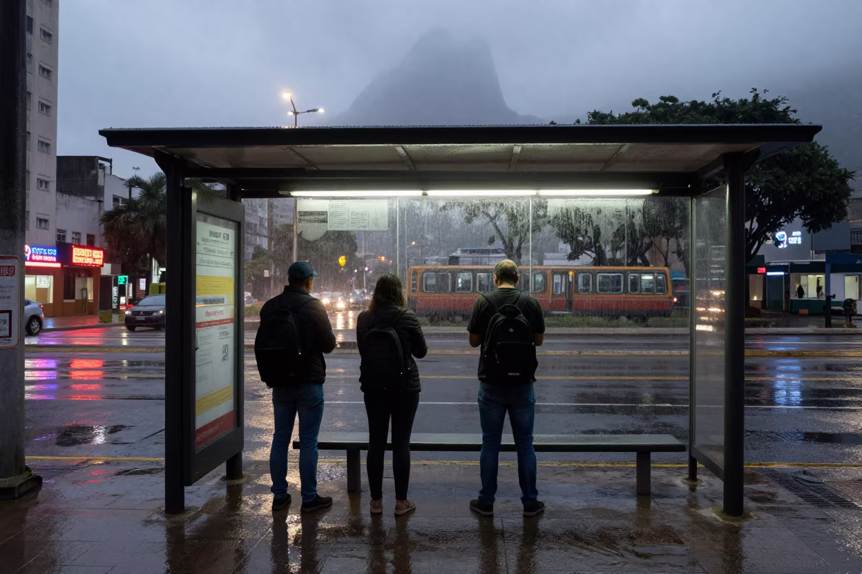 Rio Commuters Under Neon Rain Before Dawn in beside a steamed-up bus shelter in Rio de Janeiro