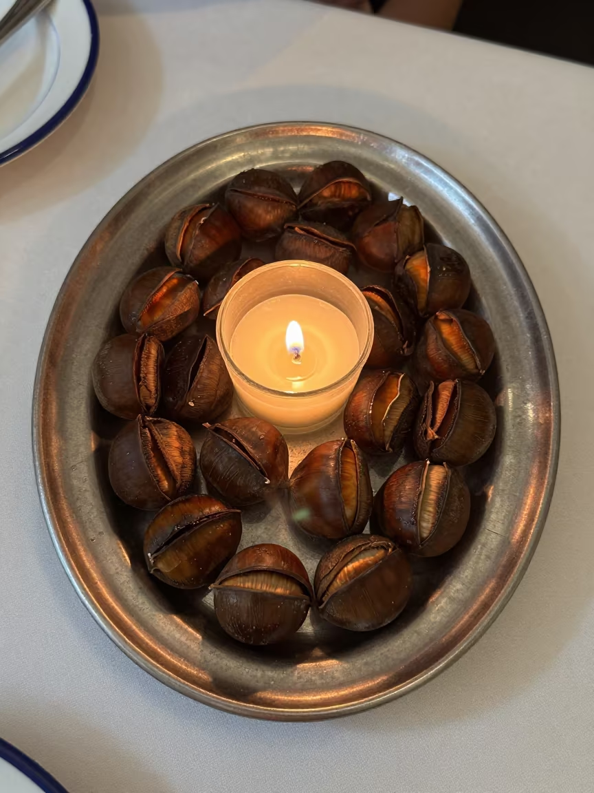 Roasted Chestnuts on Linen Table at Twilight in on a linen-covered restaurant table in Braga