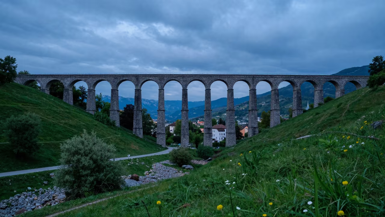 Roman Aqueduct Over Green Valley at Dusk in beside a storm surge barrier in Innsbruck