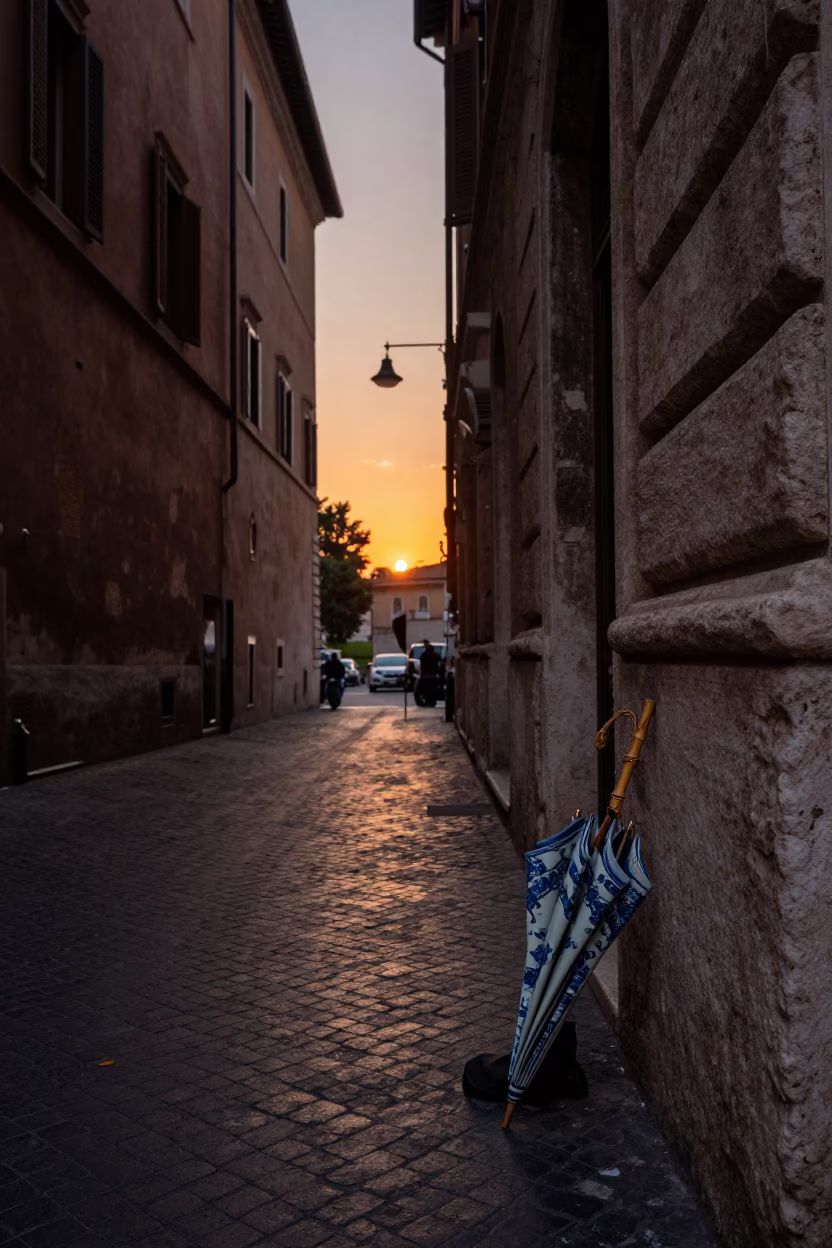 Rome Italy Dusk Street Scene with Folded Parasol and Porcelain Jar on Cobblestone in in Rome, Italy