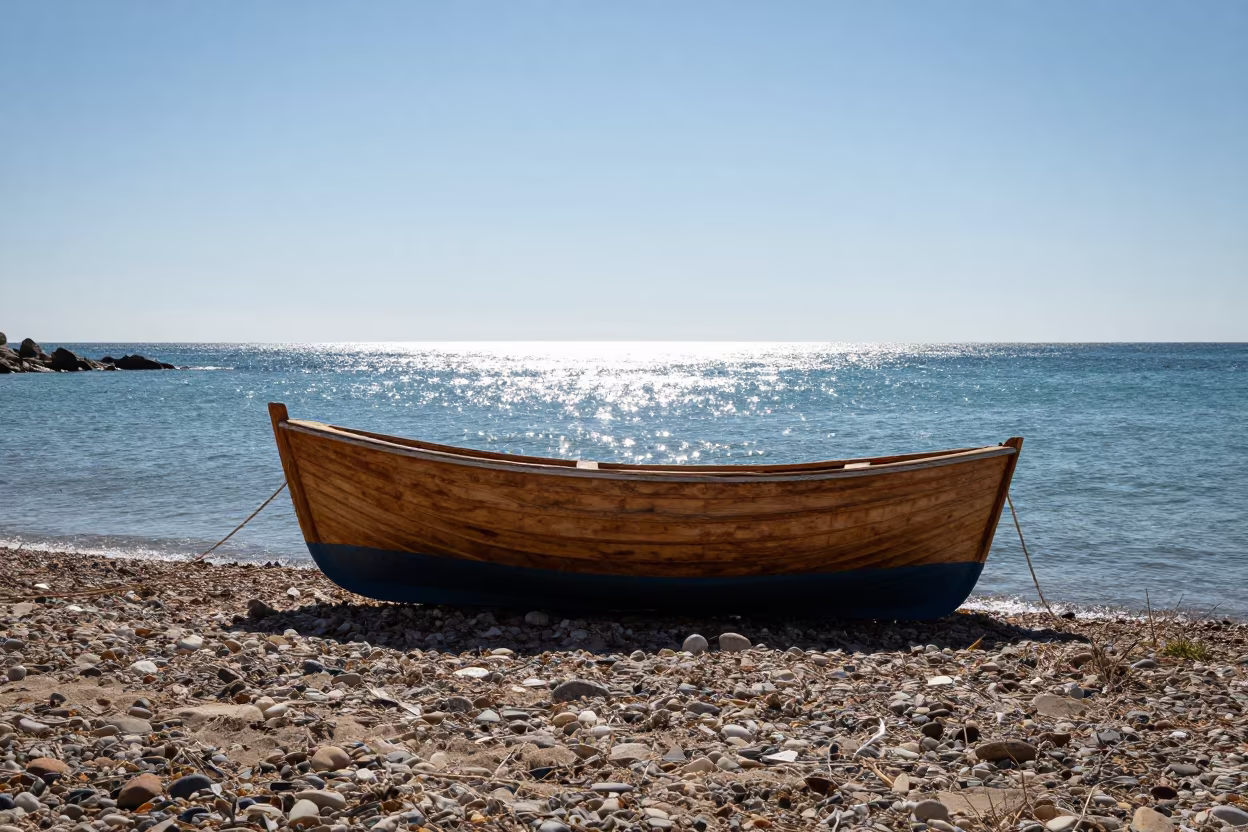 Rowboat on Pebble Beach Under Noon Sun in in Catalonia