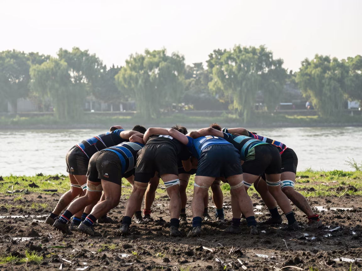 Rugby Scrum Locking on Muddy Suzhou Riverbank in by a riverbank near Suzhou